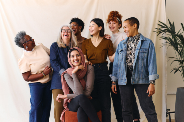 Group of cheerful mixed age range multi ethnic women celebrating International Women's Day