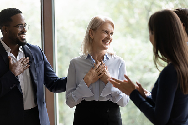 A group of people talking and smiling