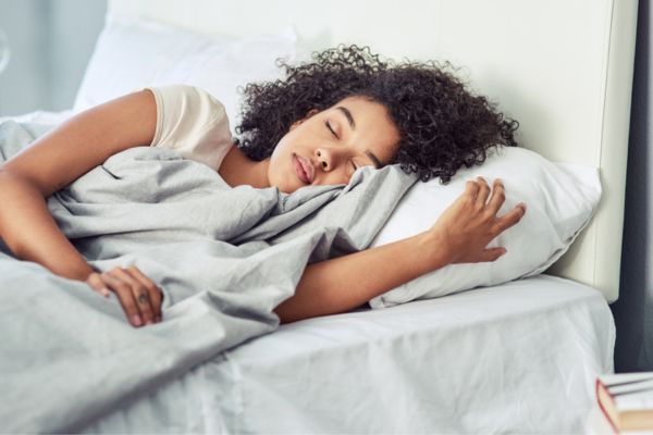 Young woman sleeping peacefully in bed.