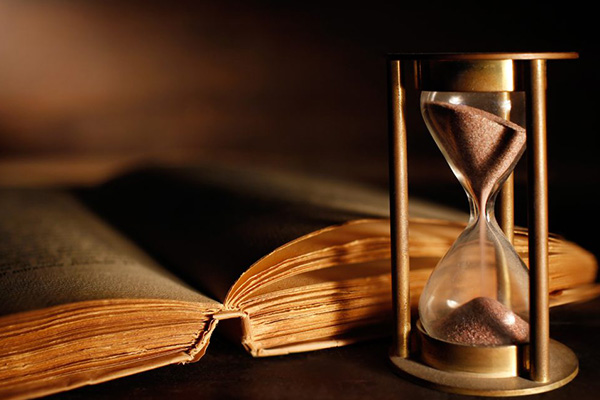 An open book next to an hourglass