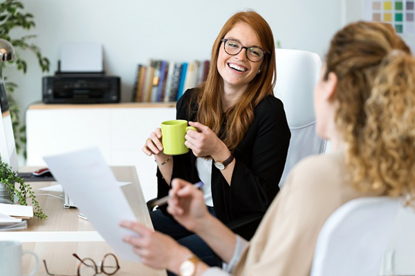 Two women at a table in a joyful conversation