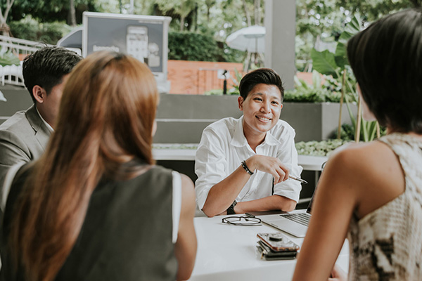 A group of people in a conversation at a table