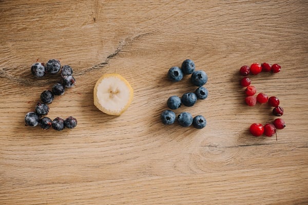 Fruit on a wood tabletop arranged to spell "2025"