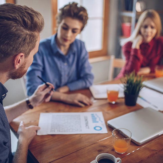 Group of people at a table working out a contract