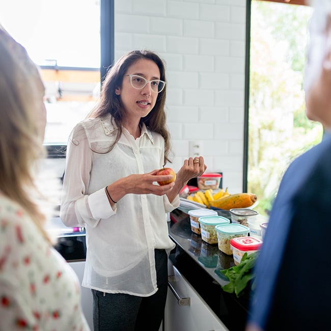 A woman talking to others about food