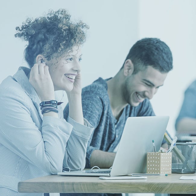 People smiling while working at a table