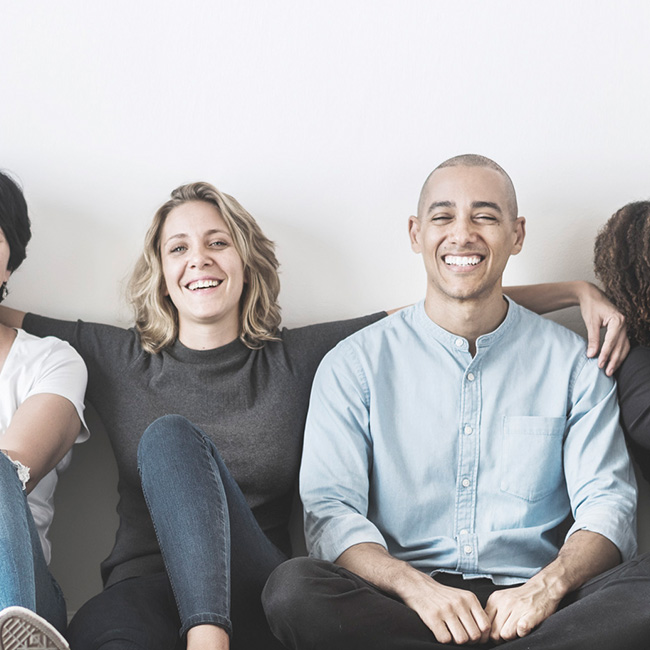 Group of smiling people sitting together